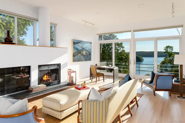 a living room with furniture and floor to ceiling windows
