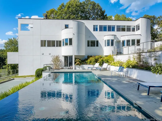 a view of house with a yard and sitting area