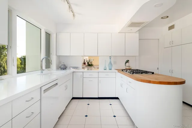 a kitchen with a stove a refrigerator and a sink
