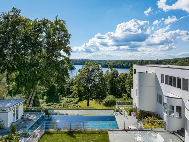 a view of a swimming pool with an outdoor seating and a garden