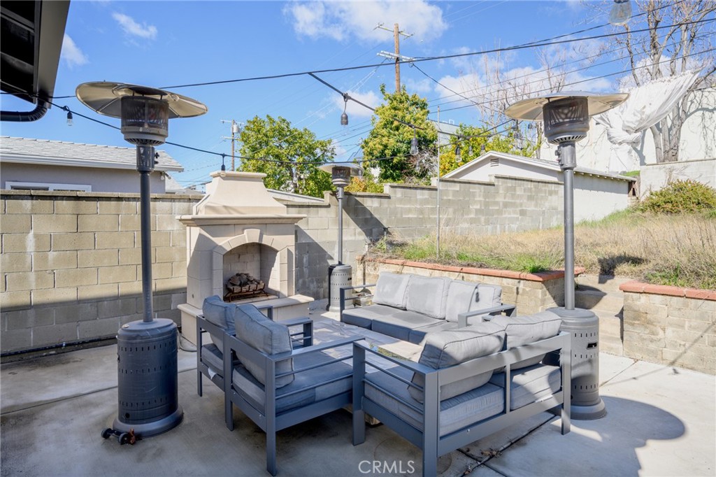 6625 Shadygrove Street Tujunga, CA 91042 - Photo 25 of 25 a living room with furniture a fireplace and a table