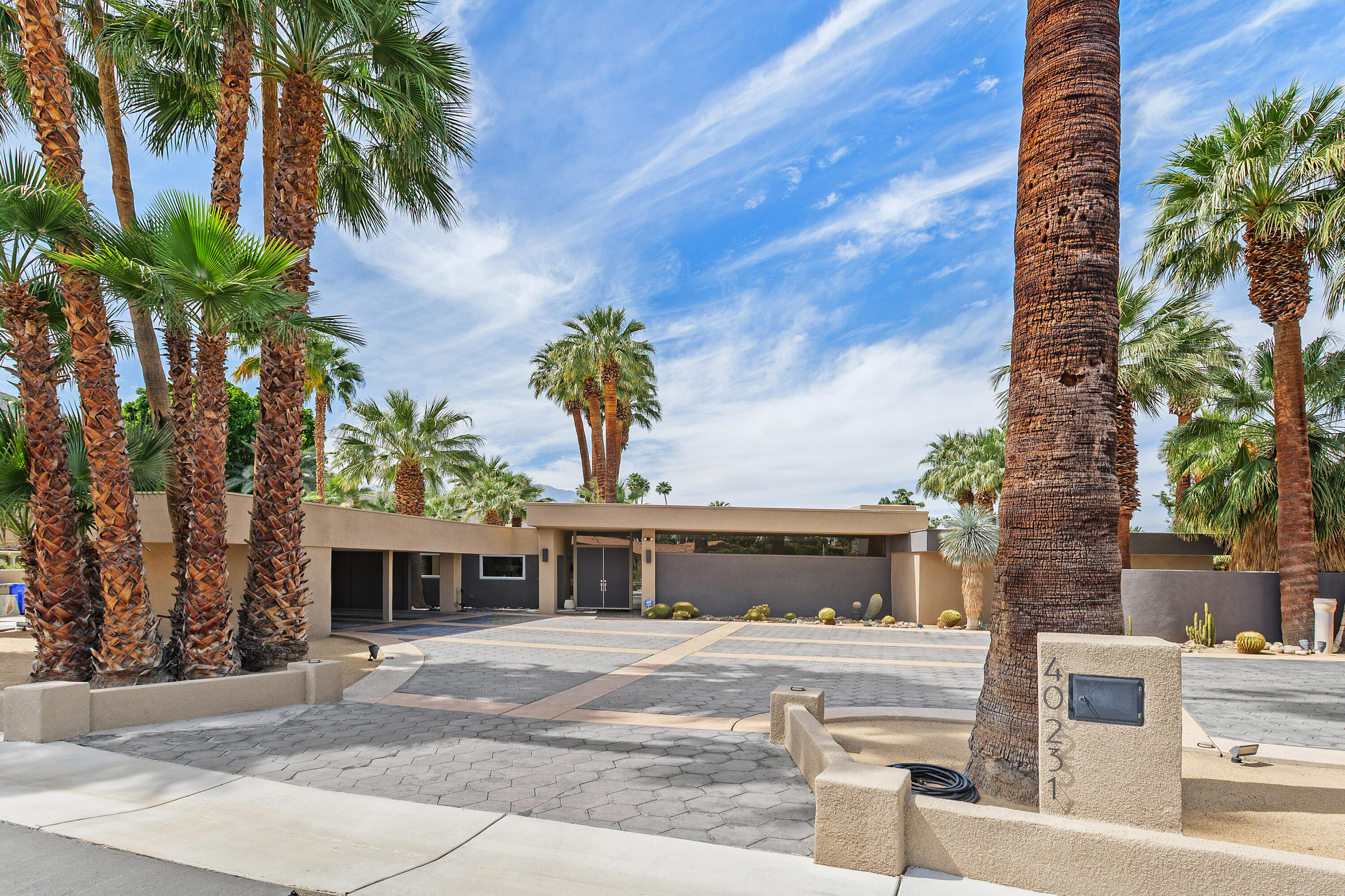 40231 Club View Drive Rancho Mirage, CA 92270 - Photo 47 of 53 a front view of a house with a yard and garage