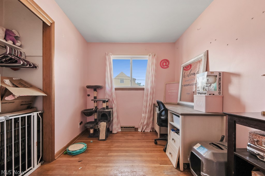 611 Herbert Road Akron, OH 44312 - Photo 20 of 30 This room features wood-finish flooring, a window offering natural light, and a built-in closet with shelving and hanging space