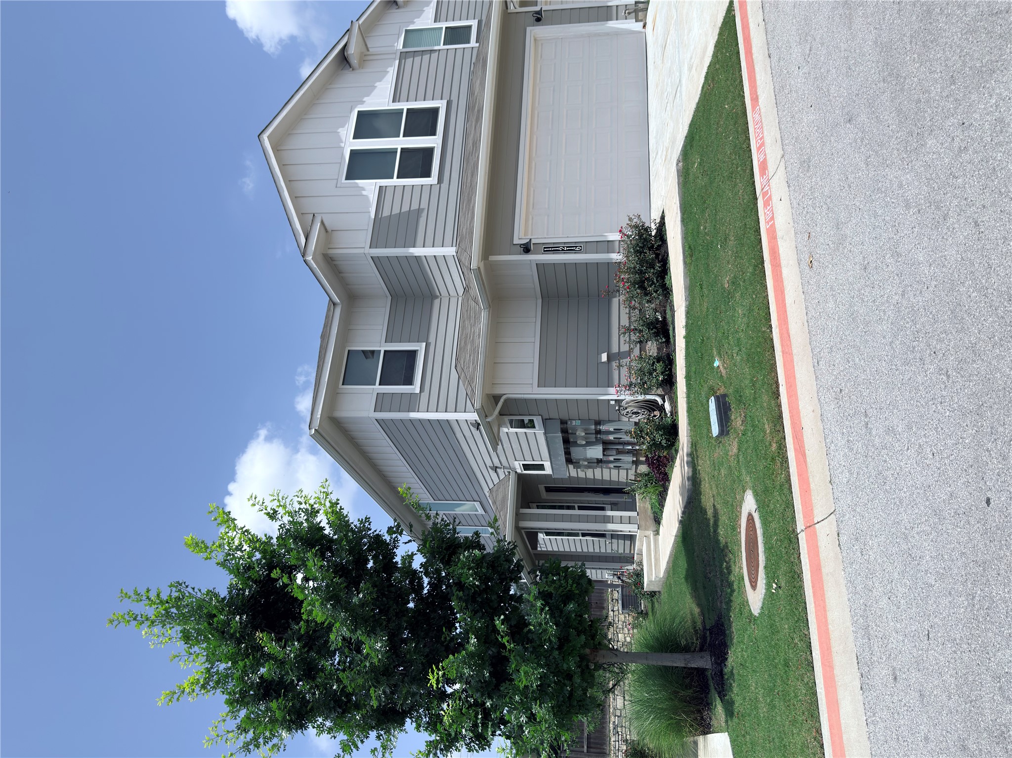 11216 Gadsen Lane Austin, TX 78754 - Photo 1 of 36 A well-maintained facade features a clean driveway and landscaped planting beds.
