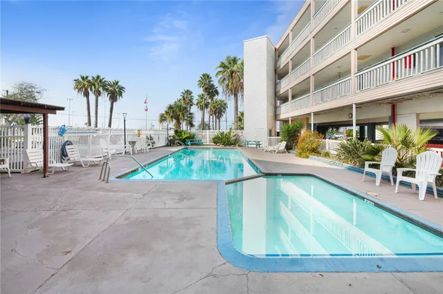 a swimming pool with outdoor seating and yard