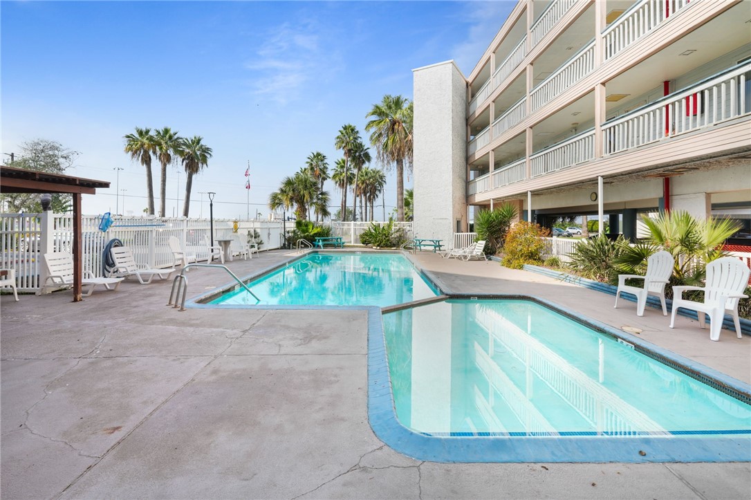 3938 Surfside Boulevard, Unit 1139 Corpus Christi, TX 78402 - Photo 12 of 14 a swimming pool with outdoor seating and yard