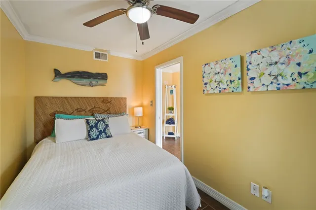 a bedroom with a bed and a painting on the wall