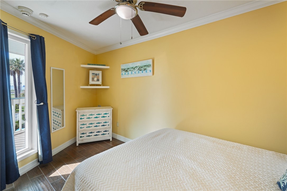 3938 Surfside Boulevard, Unit 1139 Corpus Christi, TX 78402 - Photo 9 of 14 a bedroom with a bed and a table