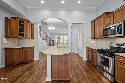 a kitchen with stainless steel appliances granite countertop a sink a stove and a microwave