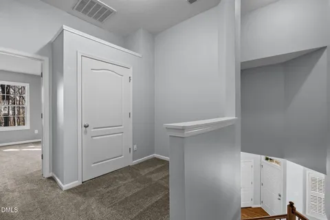 a view of a room with a ceiling fan and a window