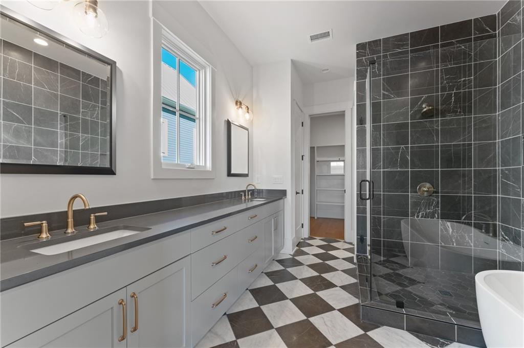 1090 Lupo Loop Chattahoochee Hills, GA 30268 - Photo 12 of 23 a bathroom with a double sink toilet a mirror and a shower