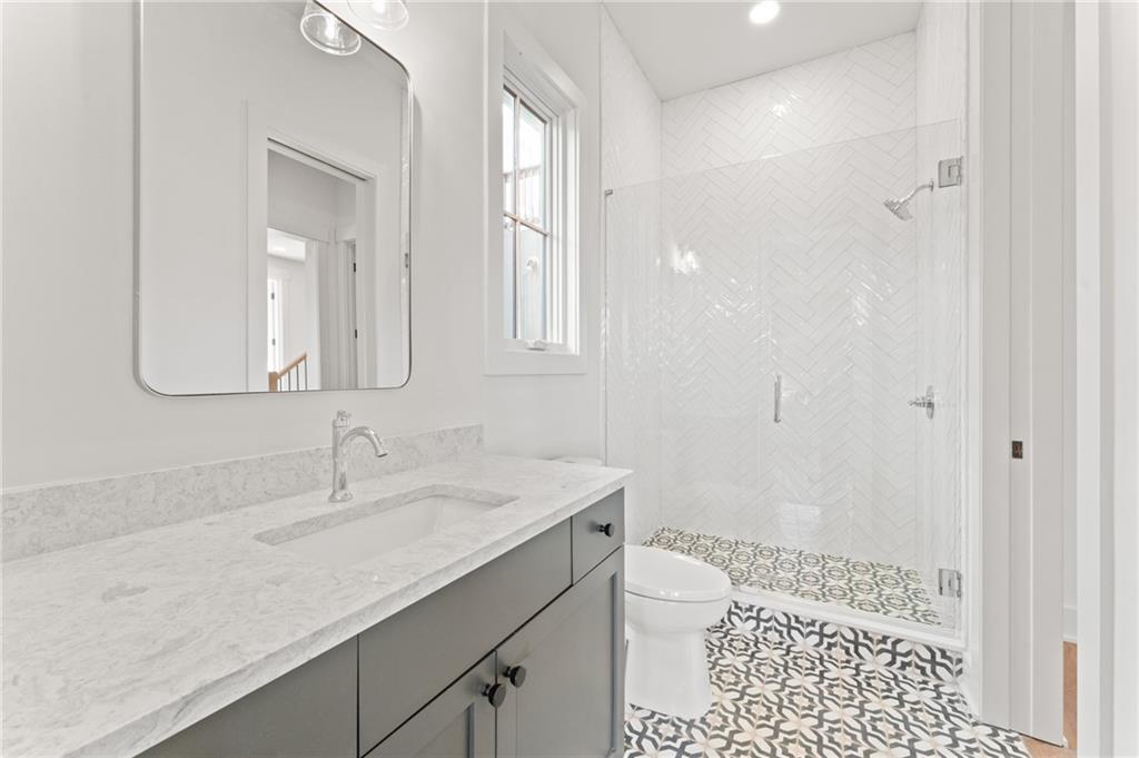 1090 Lupo Loop Chattahoochee Hills, GA 30268 - Photo 19 of 23 a bathroom with a sink a toilet and shower