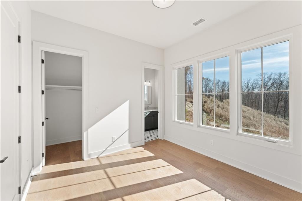 1090 Lupo Loop Chattahoochee Hills, GA 30268 - Photo 21 of 23 a view of a livingroom with wooden floor and white walls