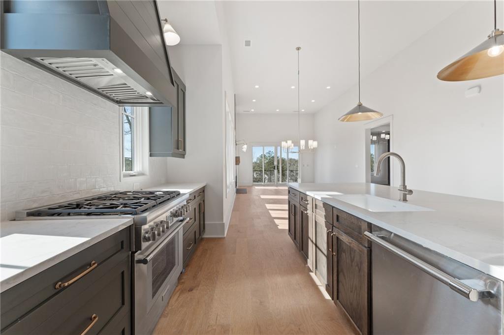 1090 Lupo Loop Chattahoochee Hills, GA 30268 - Photo 4 of 23 a kitchen with a sink stove top oven and refrigerator