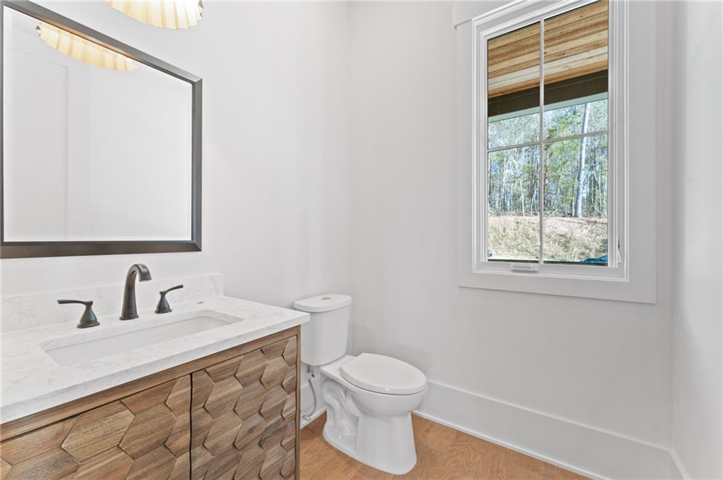 1090 Lupo Loop Chattahoochee Hills, GA 30268 - Photo 6 of 23 a white toilet sitting next to a bathroom sink