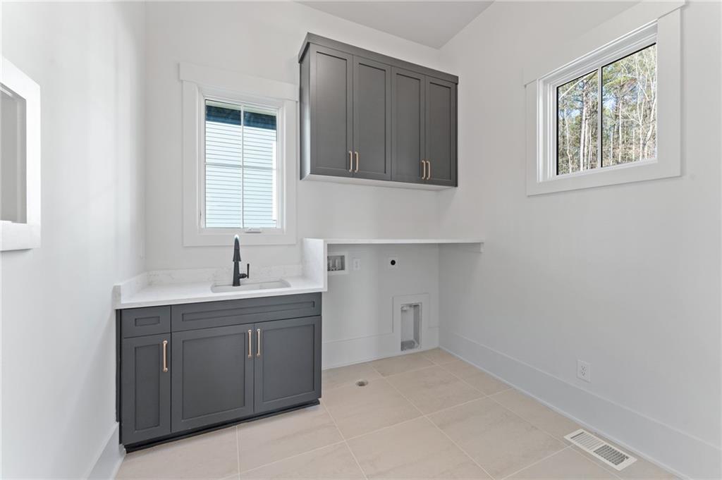 1090 Lupo Loop Chattahoochee Hills, GA 30268 - Photo 7 of 23 a room with a sink cabinets and a window