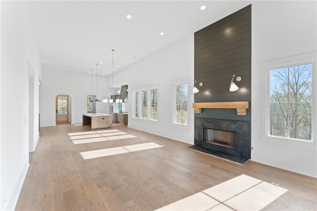 1090 Lupo Loop Chattahoochee Hills, GA 30268 - Photo 9 of 23 a view of a livingroom with wooden floor and a fireplace
