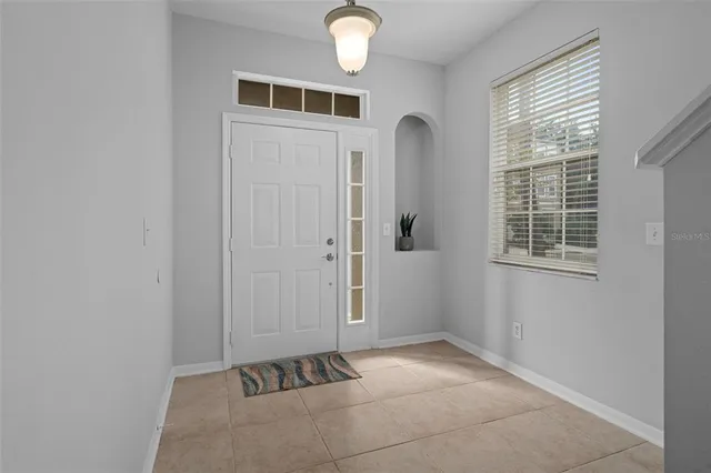 an empty room with wooden floor and ceiling fan