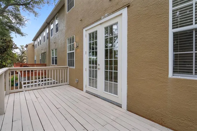 a balcony with wooden floor and fence