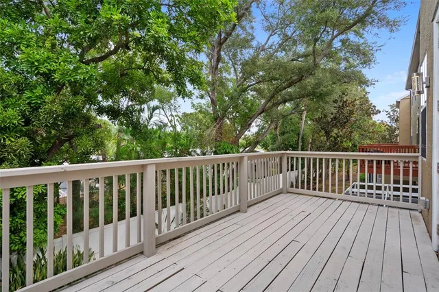 a balcony with wooden floor and fence