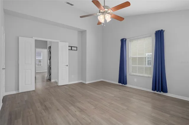 a spacious bathroom with double vanity and a mirror