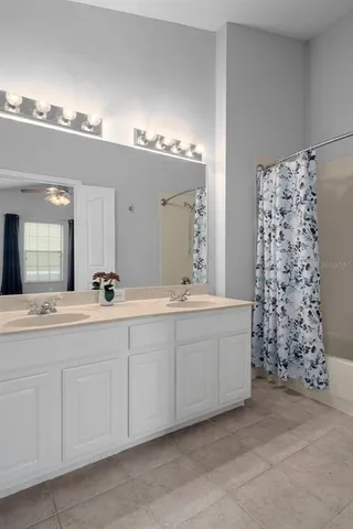 a bathroom with a double vanity sink and a bathtub