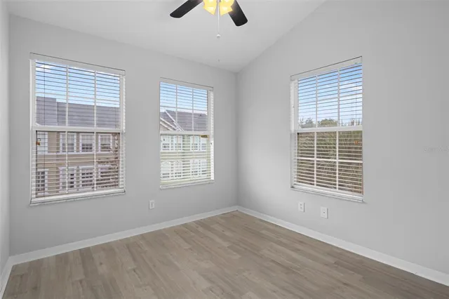 a view of an empty room with wooden floor
