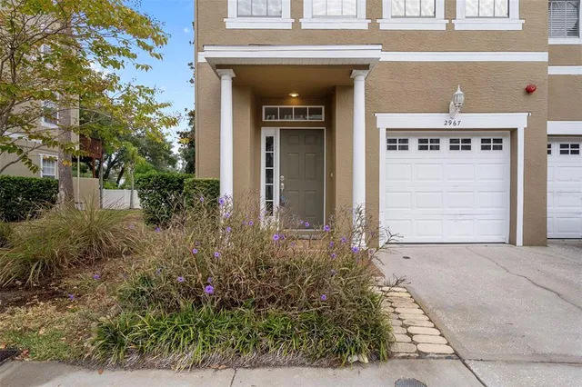front view of a house with potted plants