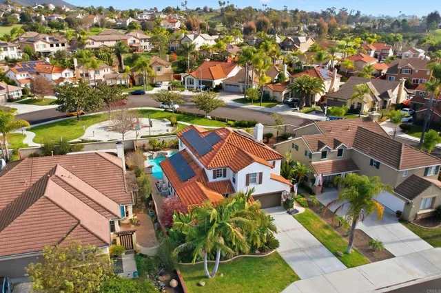 an aerial view of residential houses with outdoor space