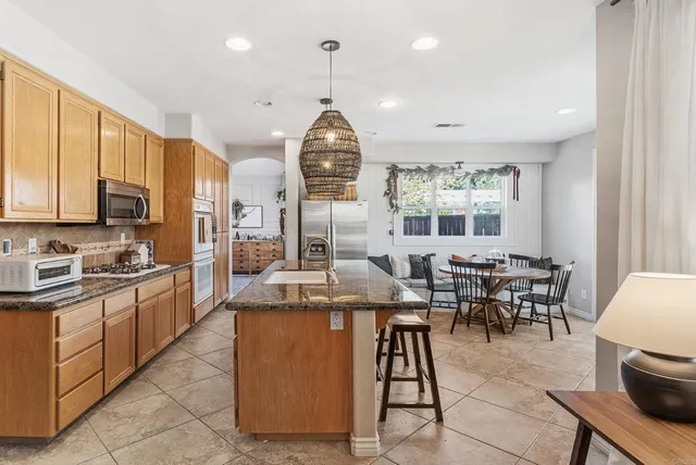 a spacious bathroom with a granite countertop sink and a mirror