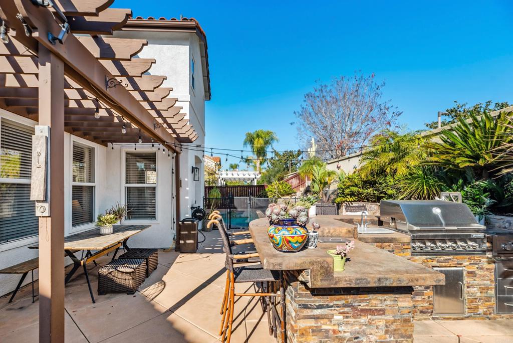 561 Chesterfield Circle San Marcos, CA 92069 - Photo 43 of 70 a view of a patio with table and chairs and potted plants