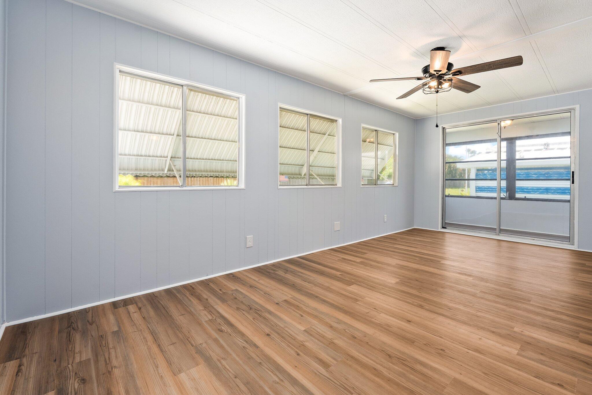 4800 Southeast Federal Highway, Unit 53 Stuart, FL 34997 - Photo 11 of 36 wooden floor in an empty room with a window
