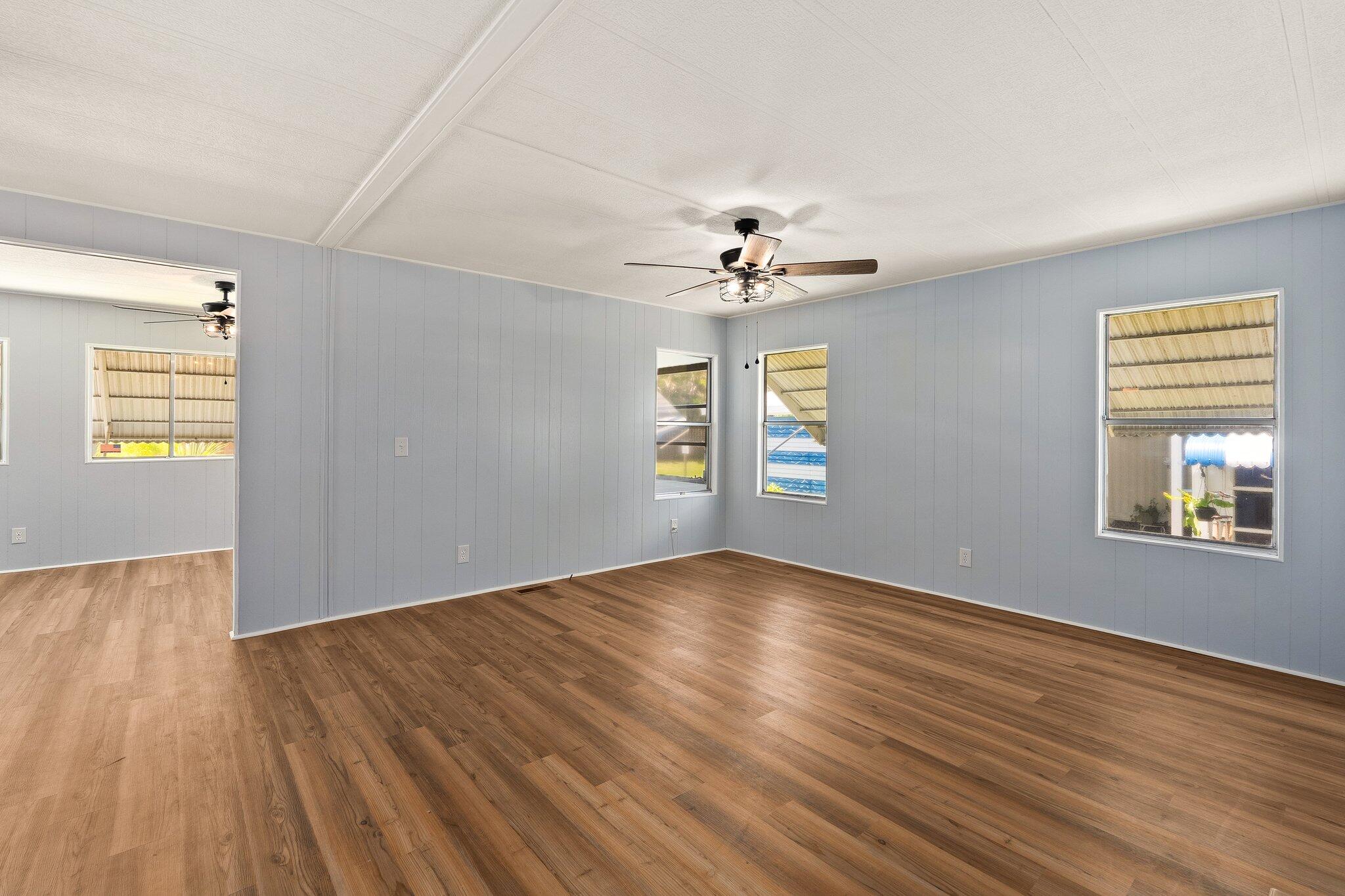 4800 Southeast Federal Highway, Unit 53 Stuart, FL 34997 - Photo 14 of 36 a view of an empty room with wooden floor and a window