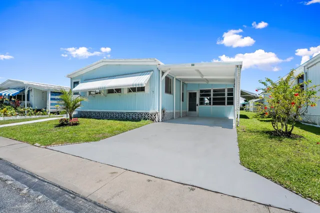 a view of a house with backyard and porch