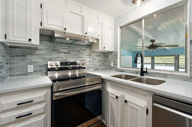 a kitchen with a sink and cabinets