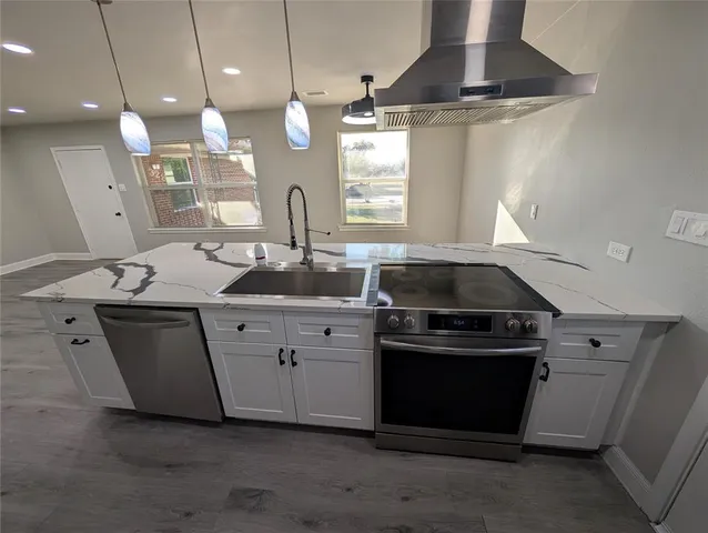 a kitchen with a stove and a sink