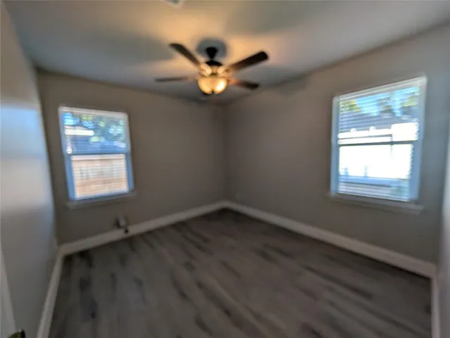 a view of wooden floor and windows in a room