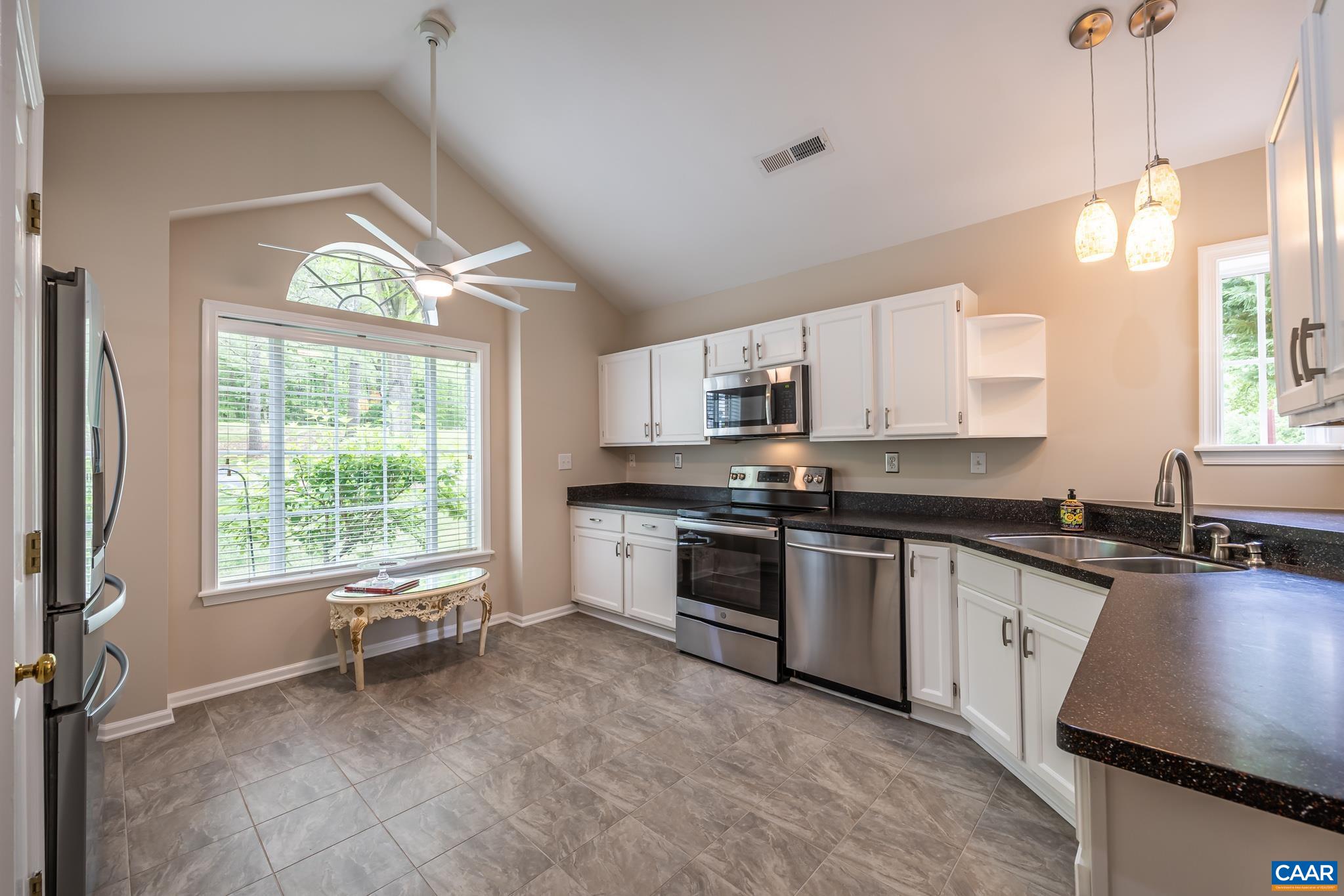 3272 Arbor Trace Charlottesville, VA 22911 - Photo 2 of 46 a kitchen with stainless steel appliances granite countertop a stove top oven a sink a dining table and chairs