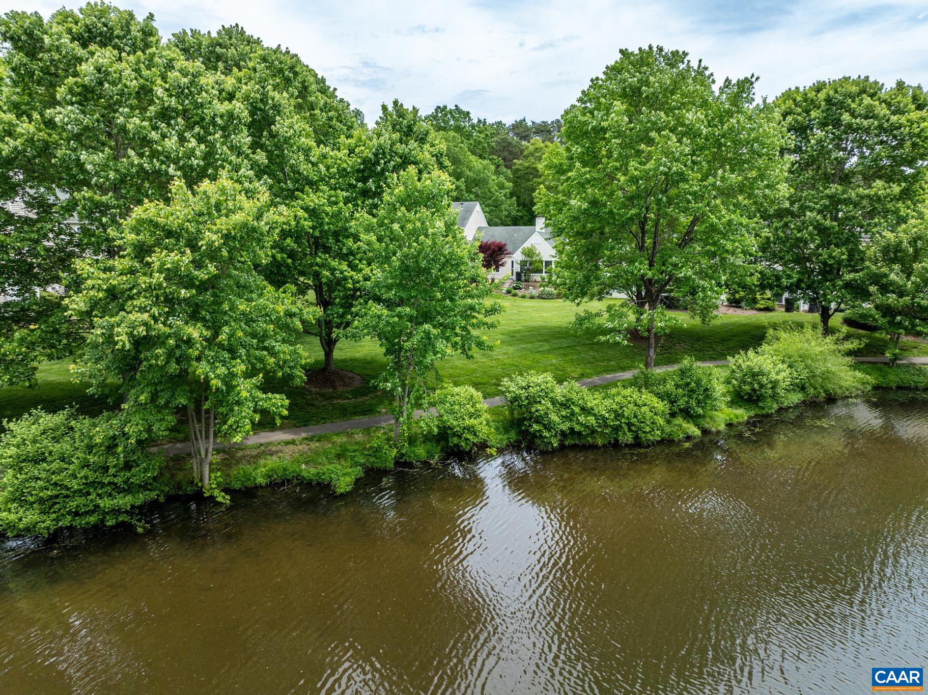 3272 Arbor Trace Charlottesville, VA 22911 - Photo 3 of 46 an aerial view of a house with a yard and lake view