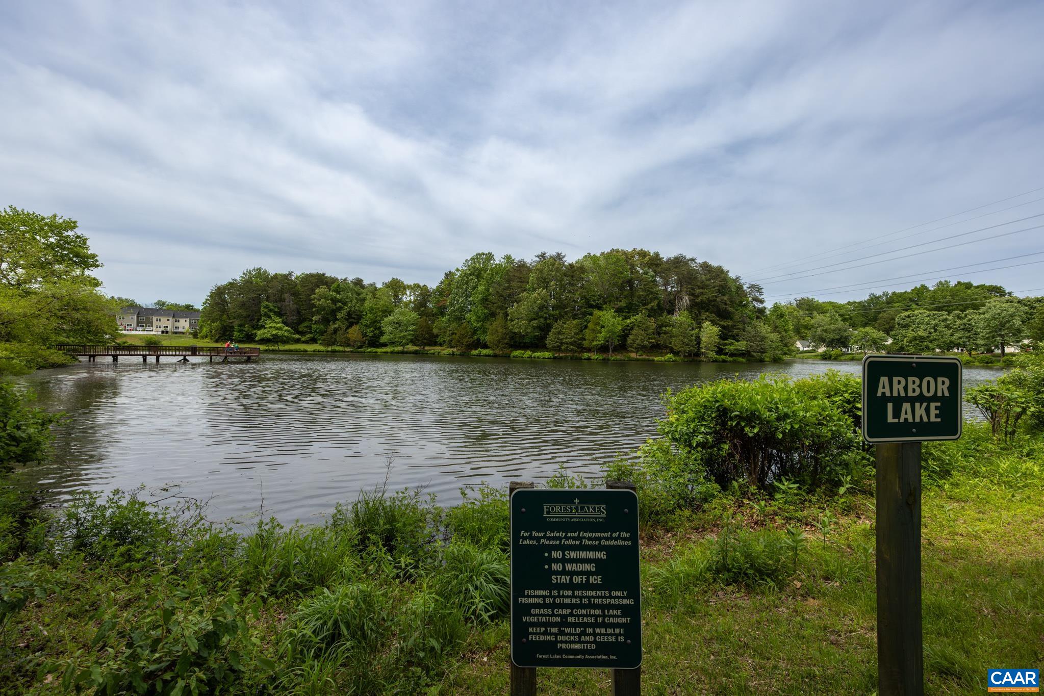 3272 Arbor Trace Charlottesville, VA 22911 - Photo 40 of 46 a view of a lake with a building in the background