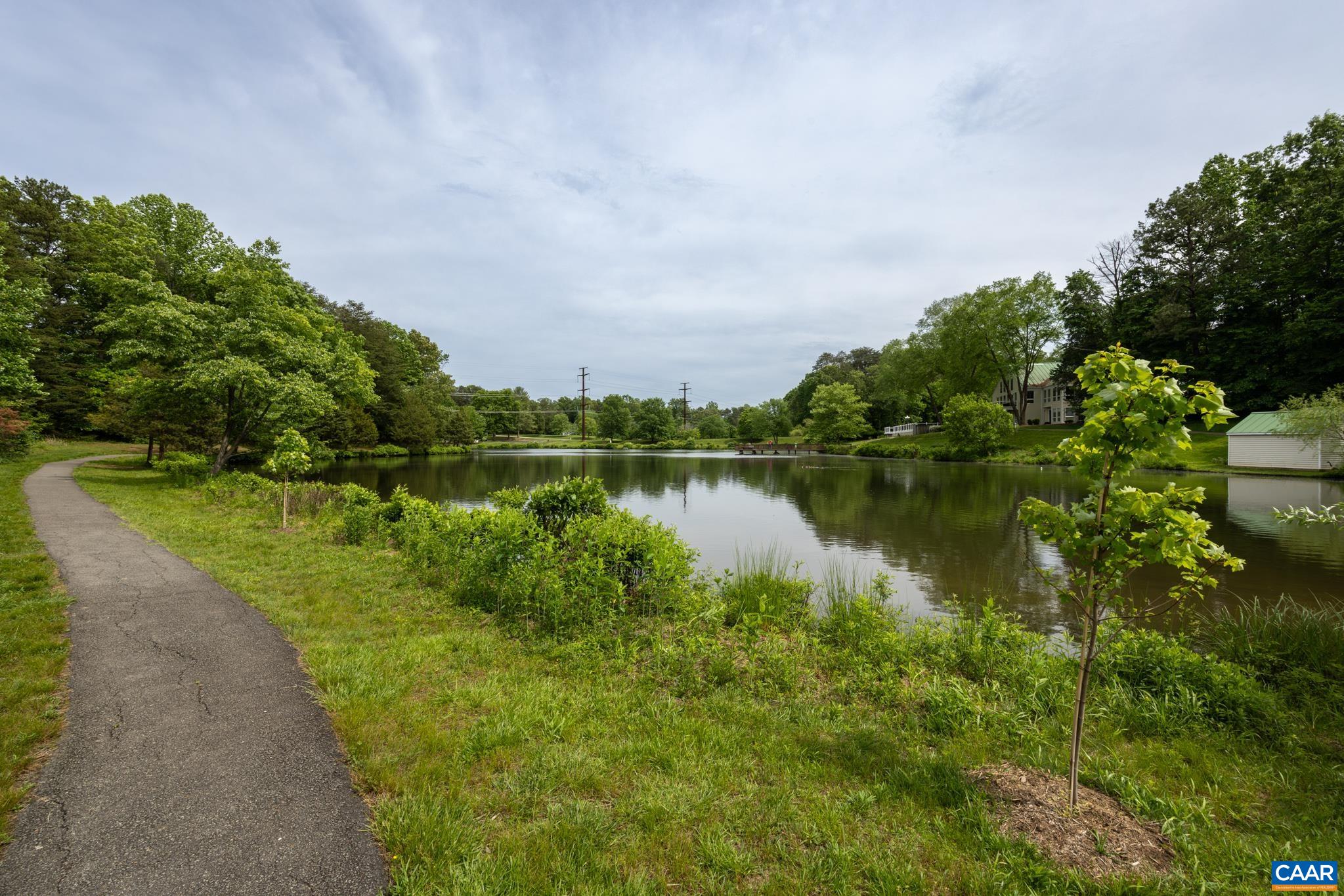 3272 Arbor Trace Charlottesville, VA 22911 - Photo 41 of 46 a view of a lake with houses in the back