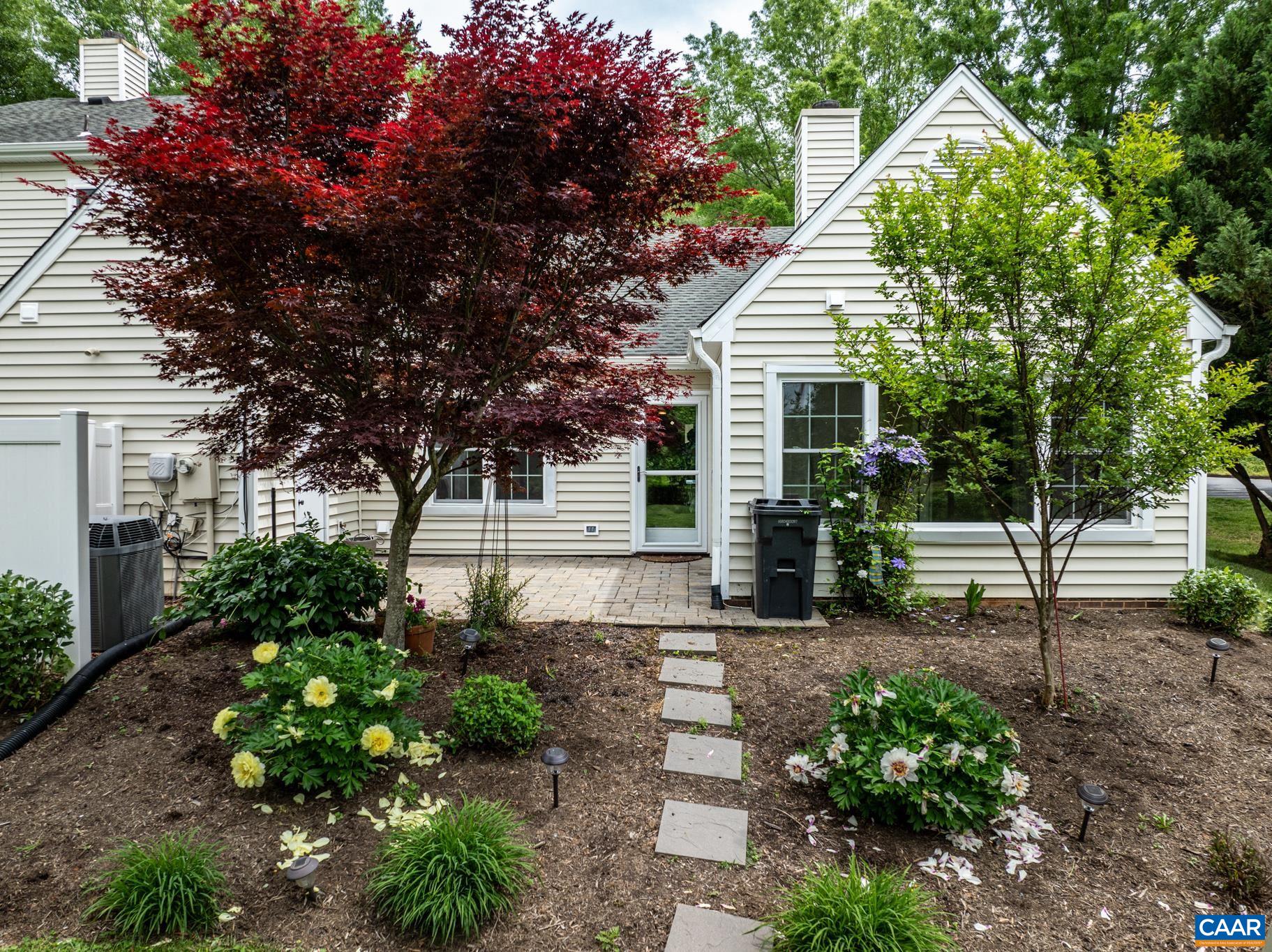 3272 Arbor Trace Charlottesville, VA 22911 - Photo 5 of 46 a front view of a house with a yard and potted plants