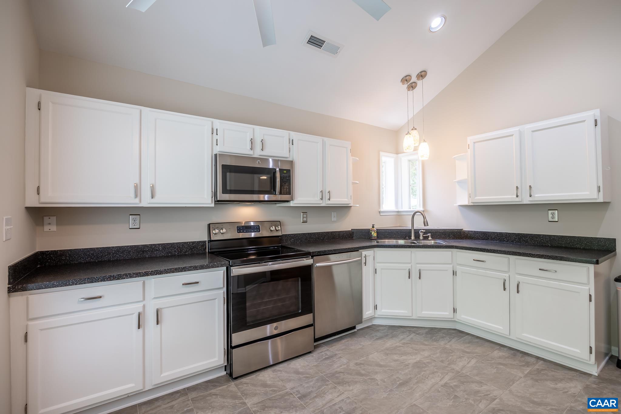 3272 Arbor Trace Charlottesville, VA 22911 - Photo 9 of 46 a kitchen with granite countertop white cabinets white stainless steel appliances with a sink and dishwasher