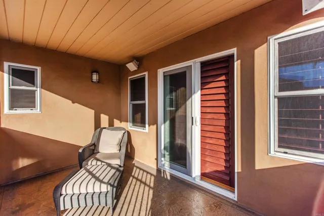 a balcony view with chairs and wooden floor