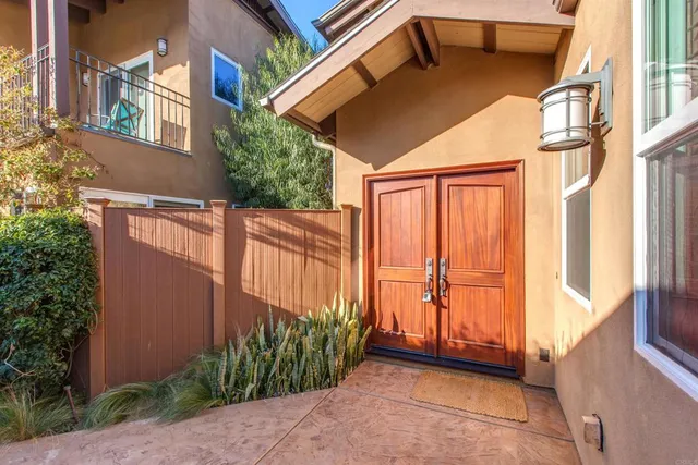 a view of a house with a window and wooden fence