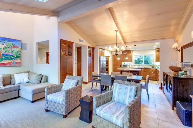 a living room with furniture and a dining table