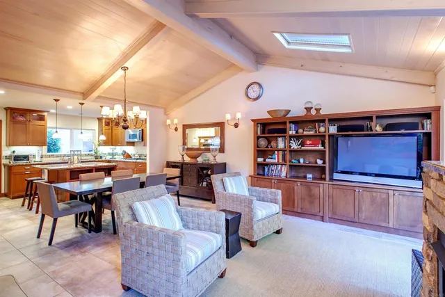 a living room with stainless steel appliances kitchen island granite countertop furniture and a kitchen view