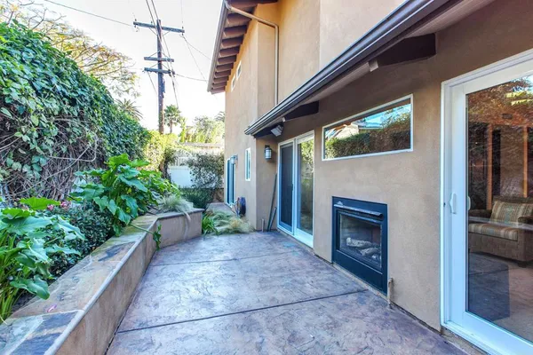 a backyard of a house with outdoor seating