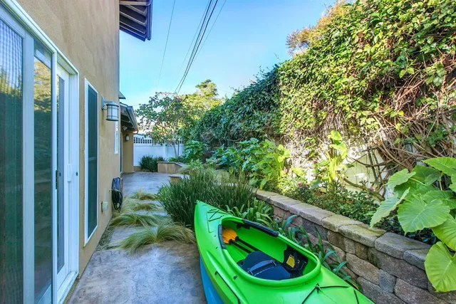 a backyard of a house with outdoor seating and trees