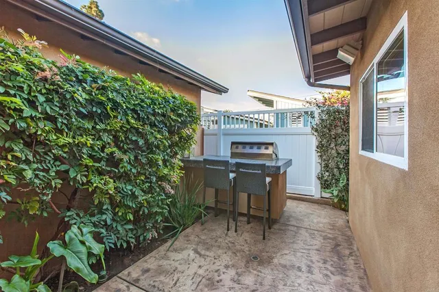 a view of a porch with furniture and a yard